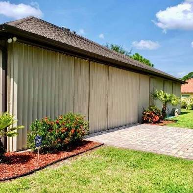 Side angle of house with accordion shutters on windows