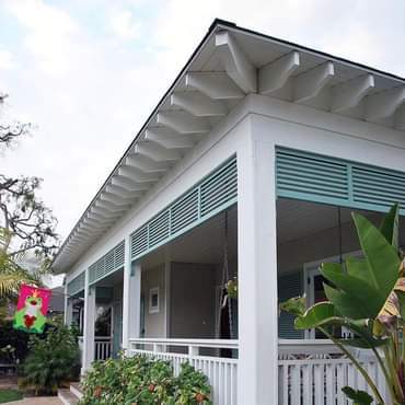 Teal Roll Down Shutters On White Porch