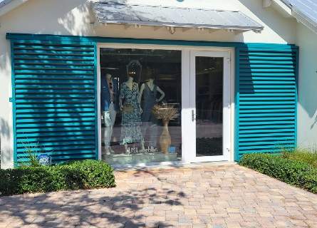 focal Custom fabricated teal gliding shutters on each side of showroom window 445x320